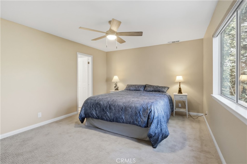 174 Golf Course Road Lake Arrowhead, CA 92391 - Photo 31 of 71 a spacious bedroom with a bed and a window