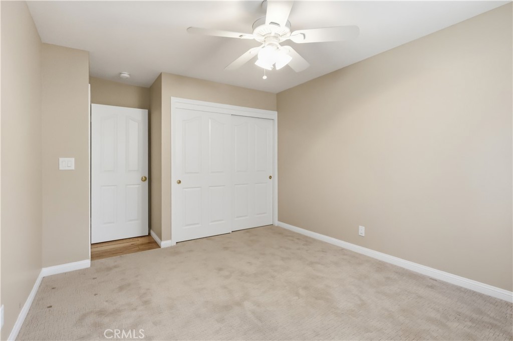 174 Golf Course Road Lake Arrowhead, CA 92391 - Photo 35 of 71 an empty room with a chandelier fan and closet area