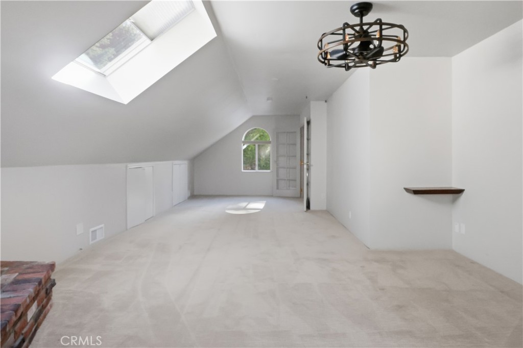 174 Golf Course Road Lake Arrowhead, CA 92391 - Photo 38 of 71 a view of an empty room with a chandelier fan