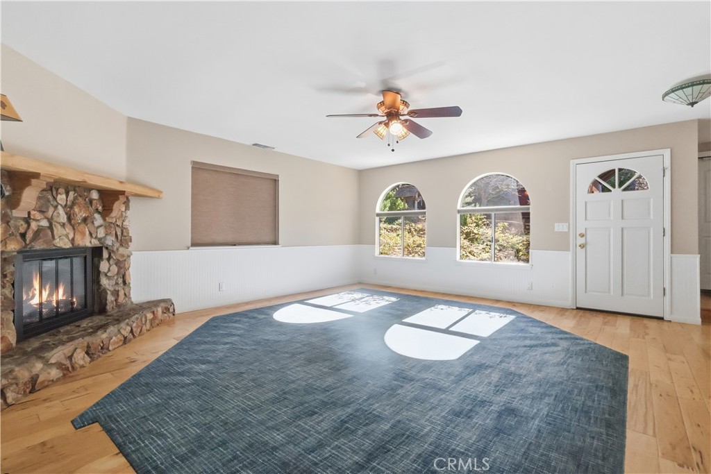 174 Golf Course Road Lake Arrowhead, CA 92391 - Photo 4 of 71 a view of an empty room and window with wooden floor