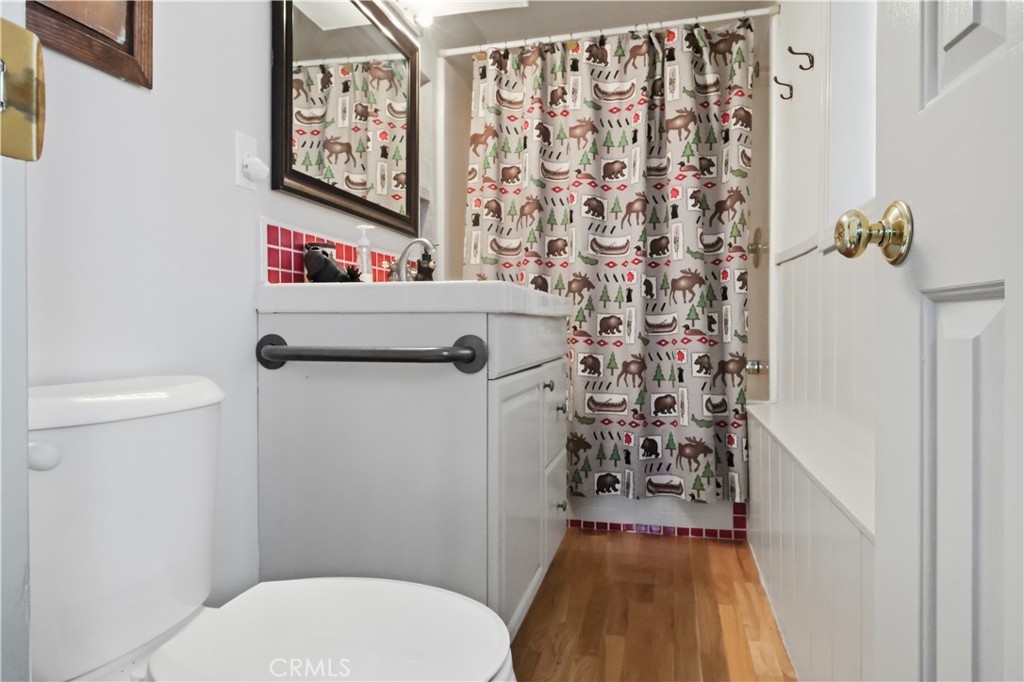 174 Golf Course Road Lake Arrowhead, CA 92391 - Photo 42 of 71 a bathroom with a toilet and a shower curtain