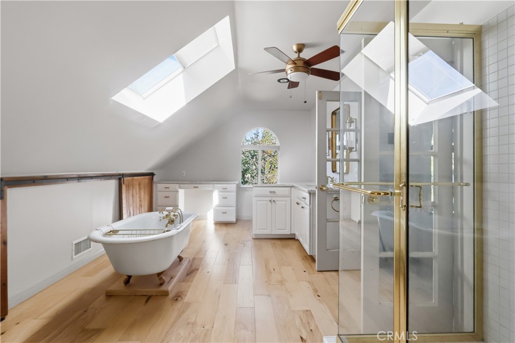 174 Golf Course Road Lake Arrowhead, CA 92391 - Photo 43 of 71 a bathroom with a bathtub and a chandelier