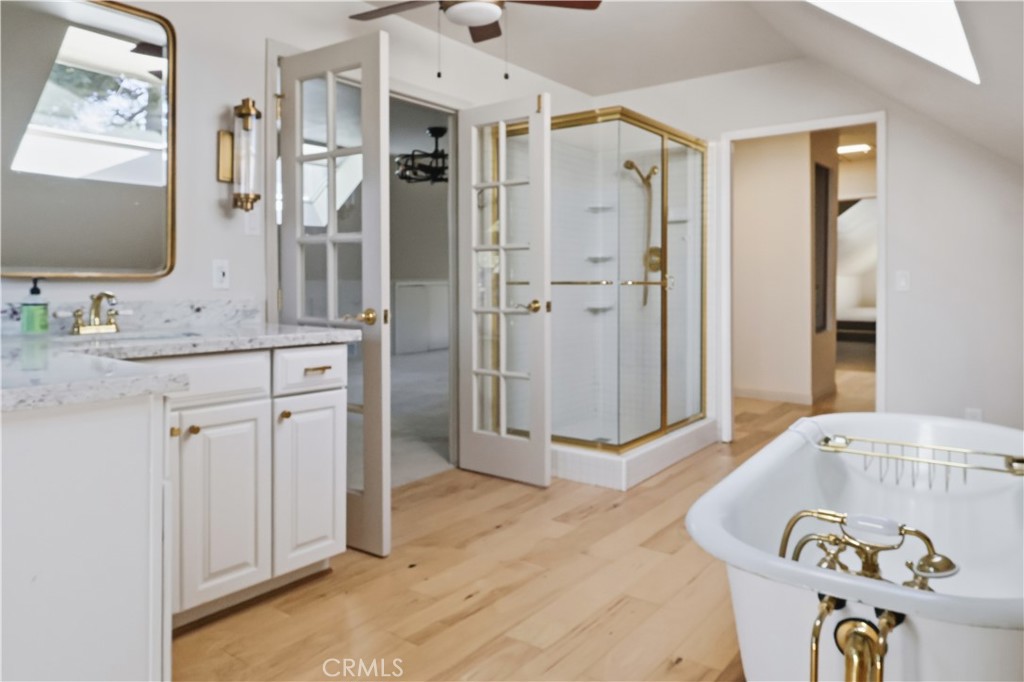 174 Golf Course Road Lake Arrowhead, CA 92391 - Photo 49 of 71 a spacious bathroom with a granite countertop sink and a mirror