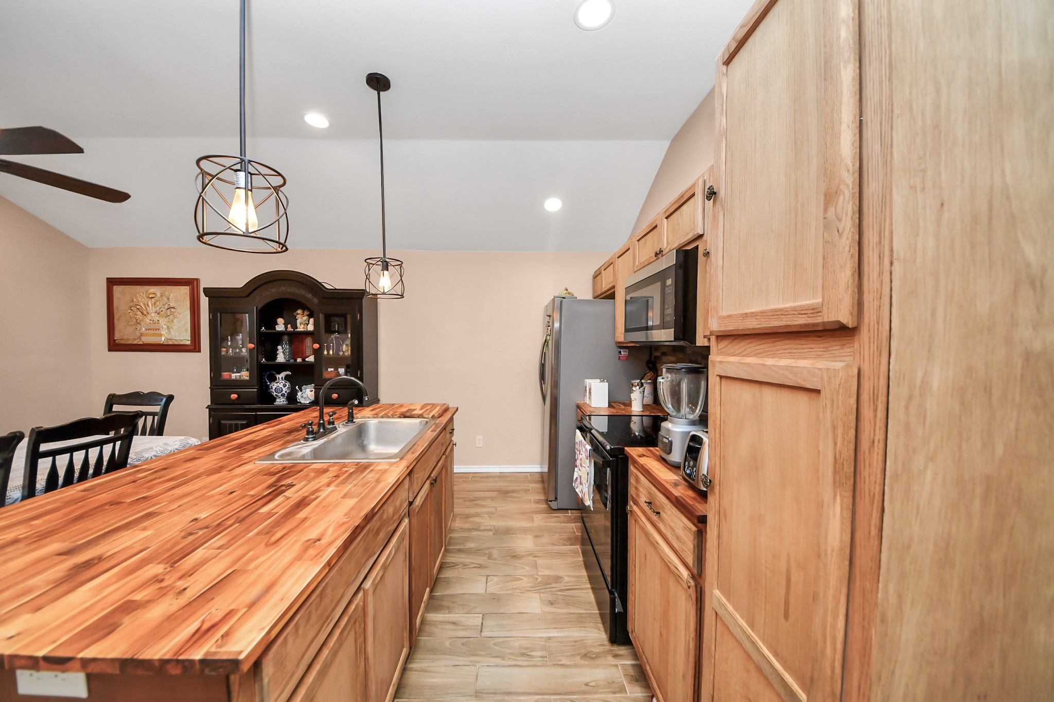14961 Lamar Road Willis, TX 77378 - Photo 12 of 31 Open kitchen with generous counter space and wood-style finishes.