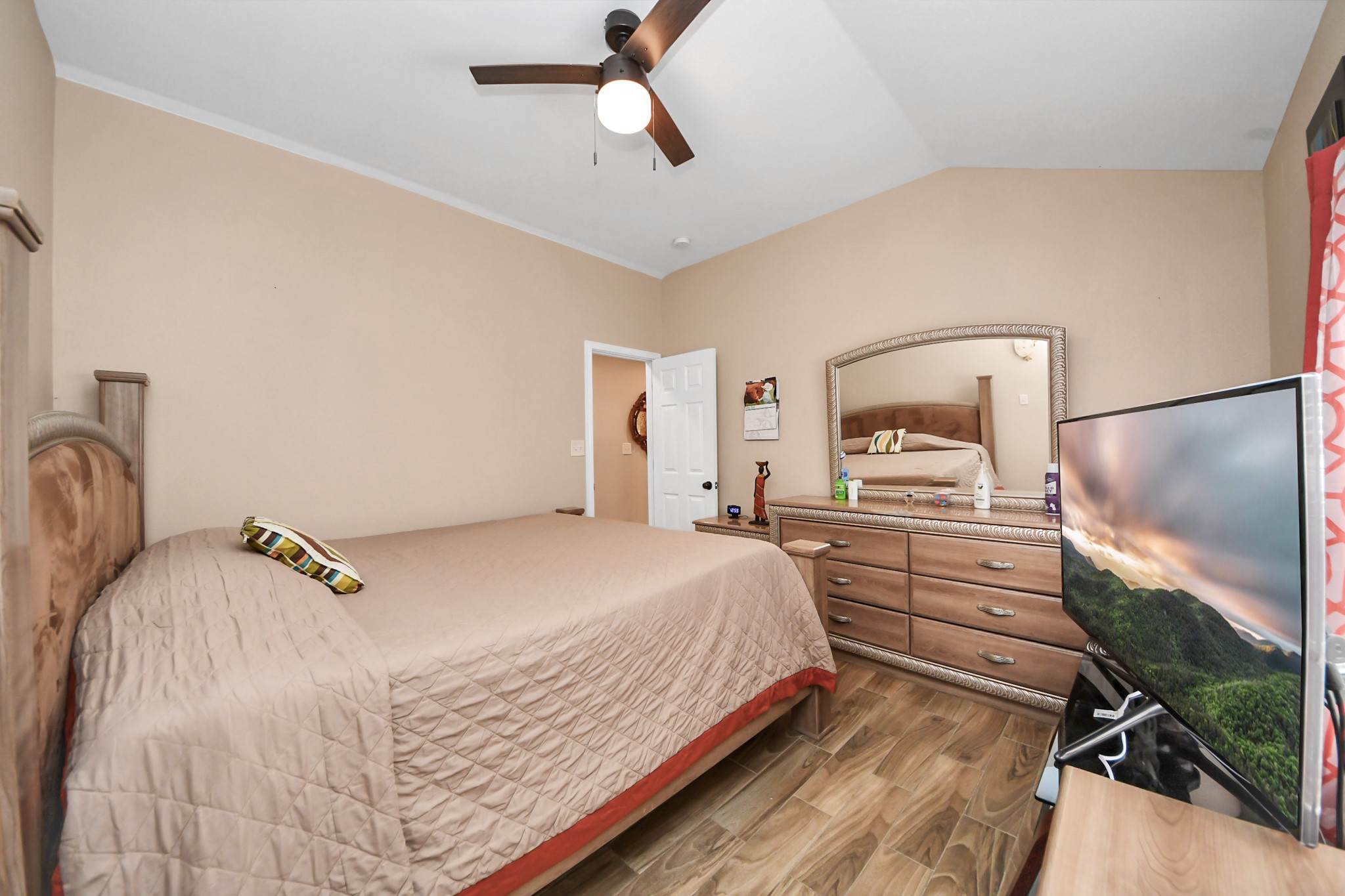 14961 Lamar Road Willis, TX 77378 - Photo 19 of 31 Relaxing primary retreat with elevated ceilings and warm finishes.