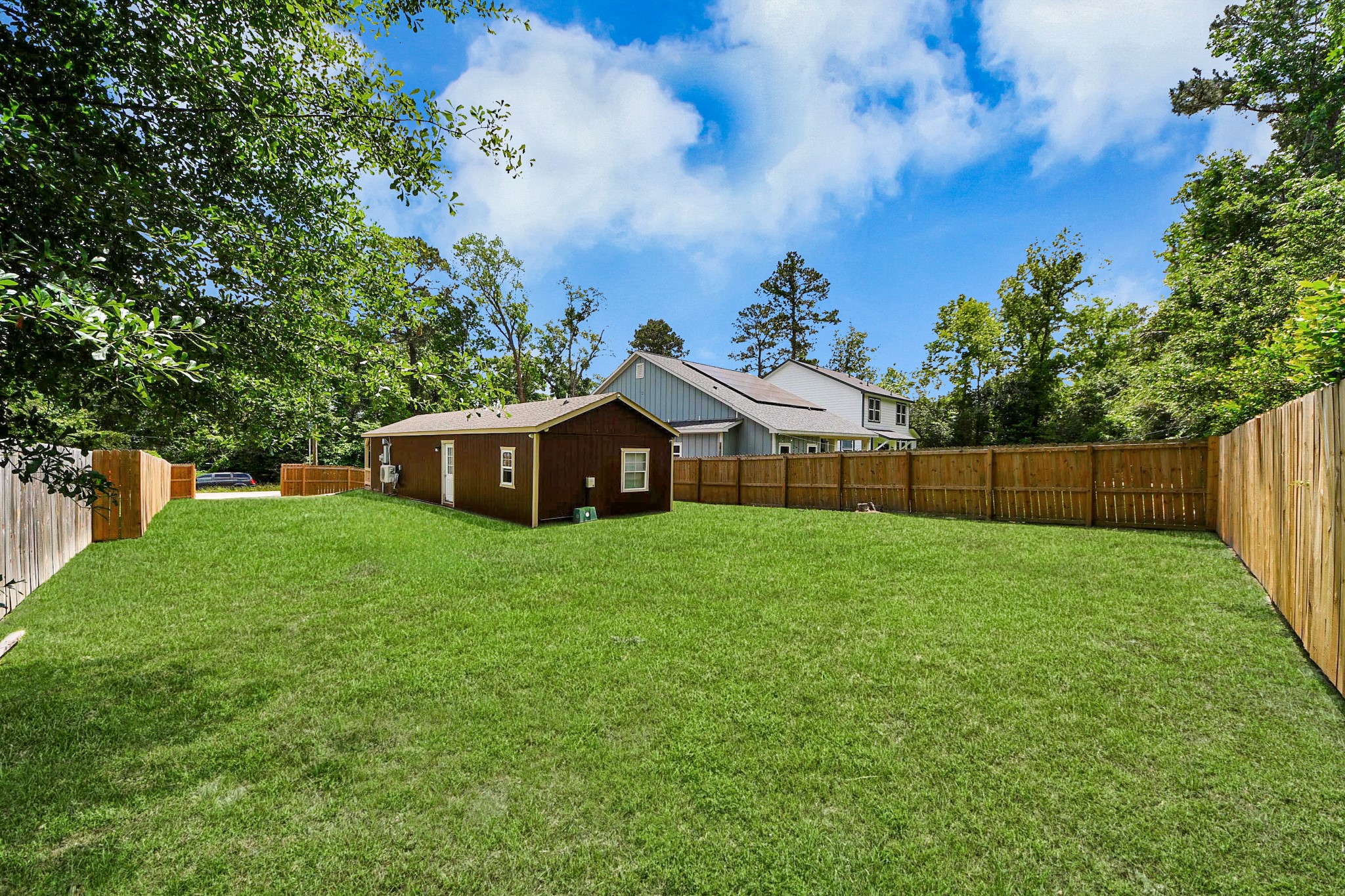 14961 Lamar Road Willis, TX 77378 - Photo 26 of 31 Expansive fenced yard offering privacy and endless possibilities.