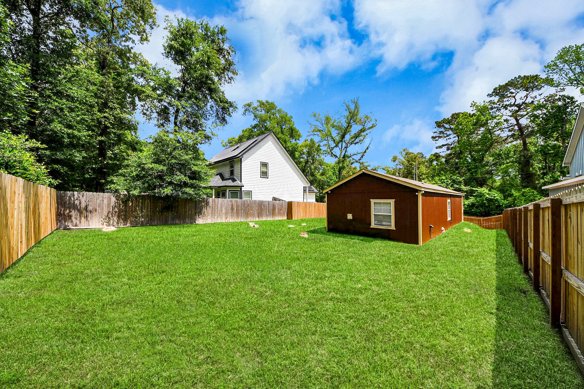 14961 Lamar Road Willis, TX 77378 - Photo 27 of 31 Backyard view highlighting the rear of the home and outdoor space.