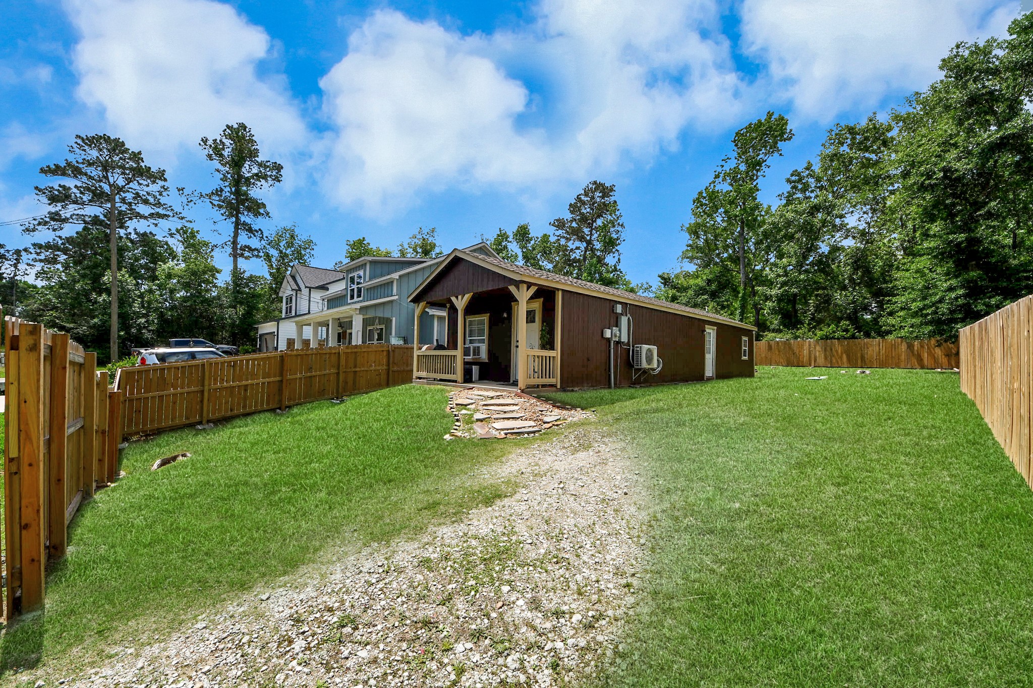 14961 Lamar Road Willis, TX 77378 - Photo 3 of 31 Side view highlighting large, cleared lot with full privacy fencing.