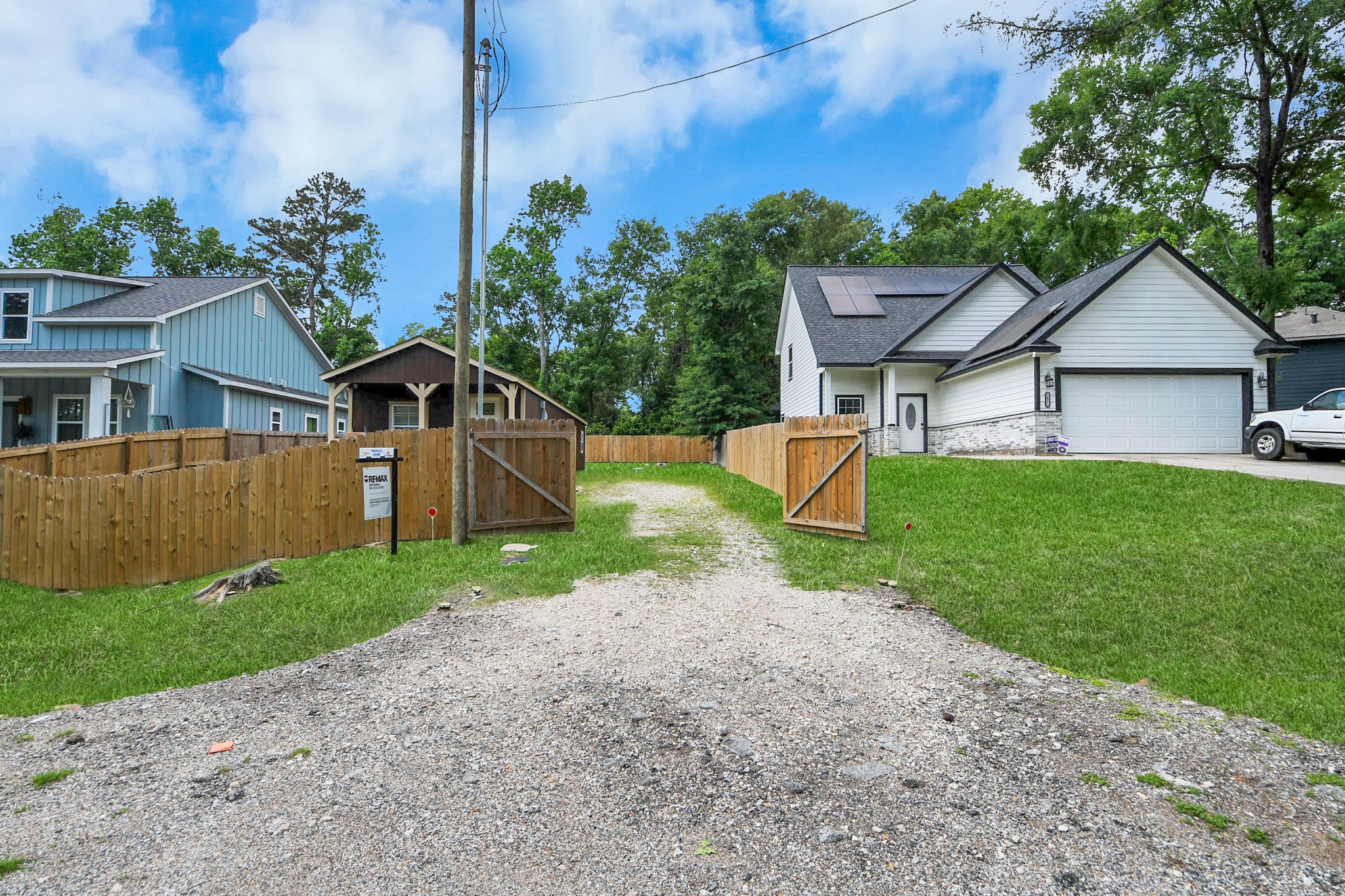 14961 Lamar Road Willis, TX 77378 - Photo 4 of 31 Front entry showcasing gated access and fully fenced lot.