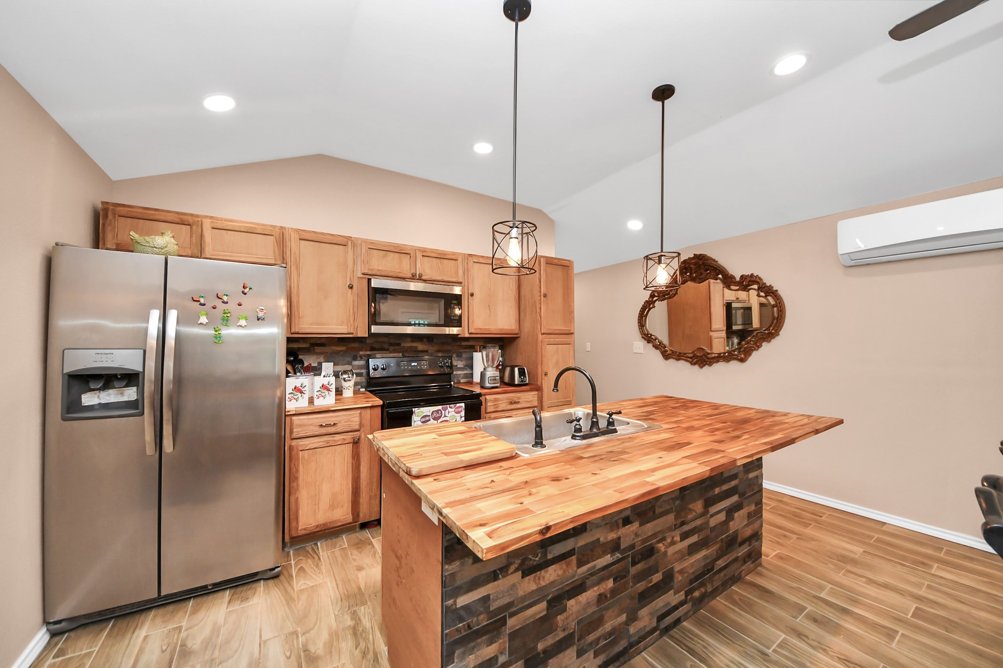 14961 Lamar Road Willis, TX 77378 - Photo 9 of 31 Functional kitchen with breakfast bar seating and ample cabinetry.