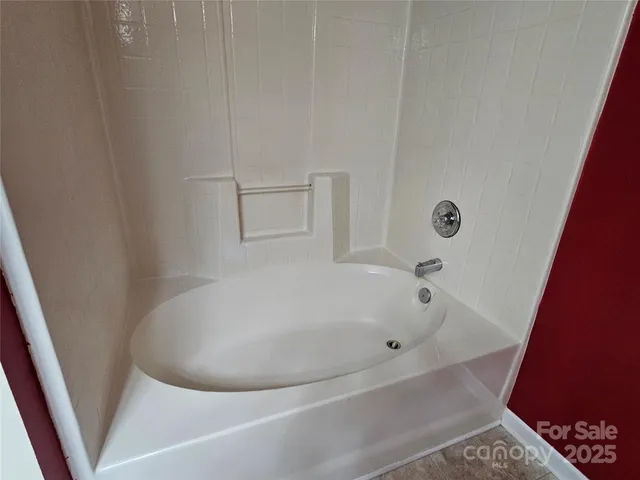 a white bath tub sitting in a bathroom