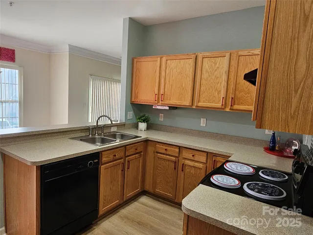 a kitchen with a sink stove and cabinets