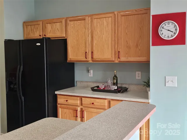 a kitchen with stainless steel appliances granite countertop a refrigerator and a stove top oven
