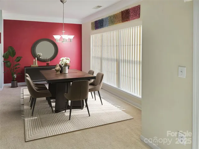 a view of a dining room with furniture and chandelier