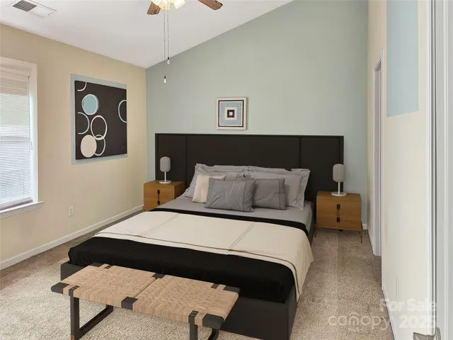 a bedroom with a bed and a painting on the wall