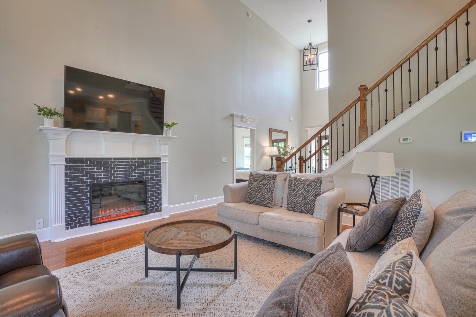 9620 Mona Road Murfreesboro, TN 37129 - Photo 21 of 58 a living room with furniture a flat screen tv and a fireplace