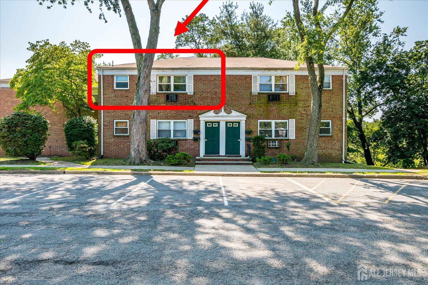 289 Main Street, Unit 4P Spotswood, NJ 08884 - Photo 2 of 22 a view of a white house with a clock on the side of it