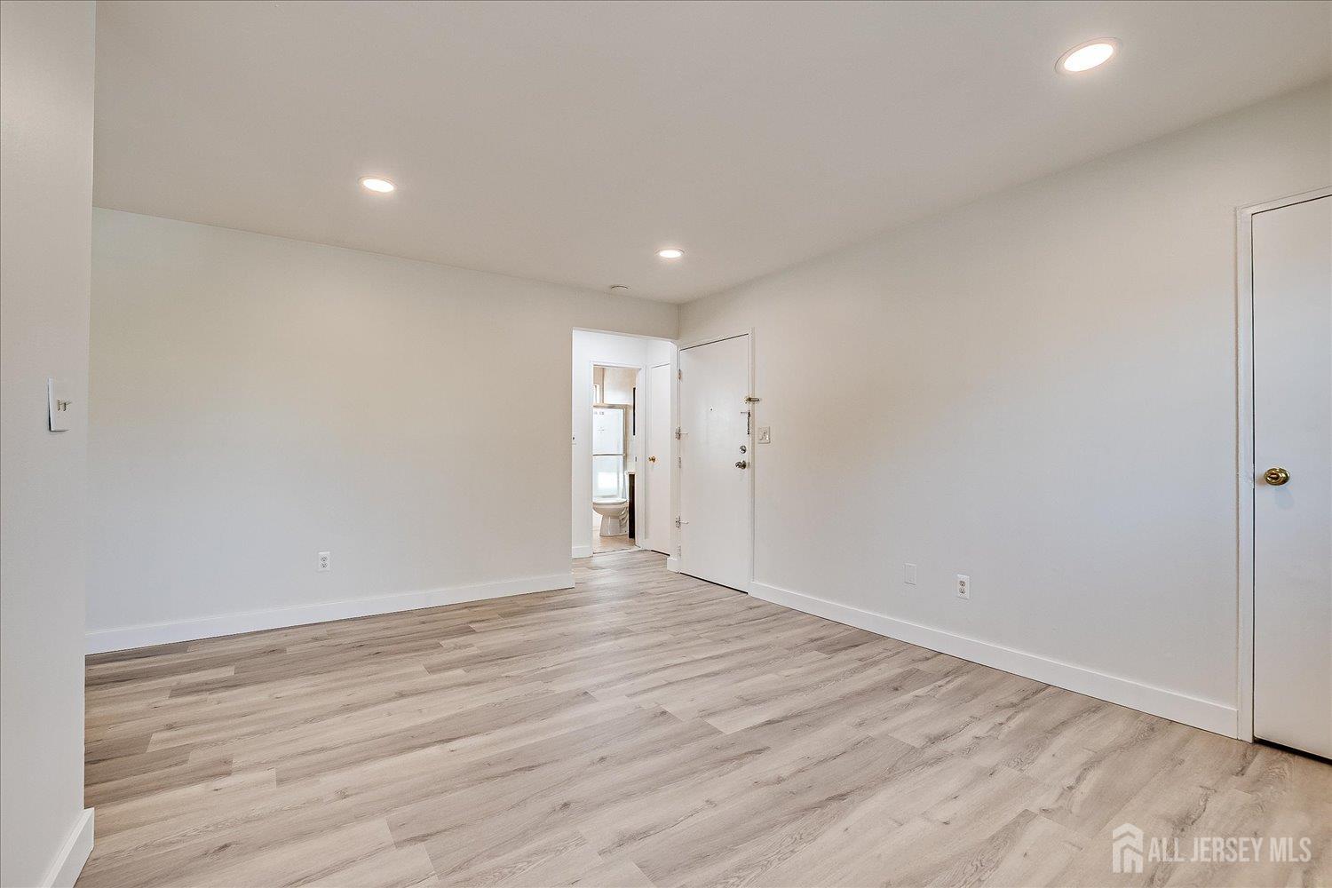 289 Main Street, Unit 4P Spotswood, NJ 08884 - Photo 7 of 22 a view of an empty room with wooden floor