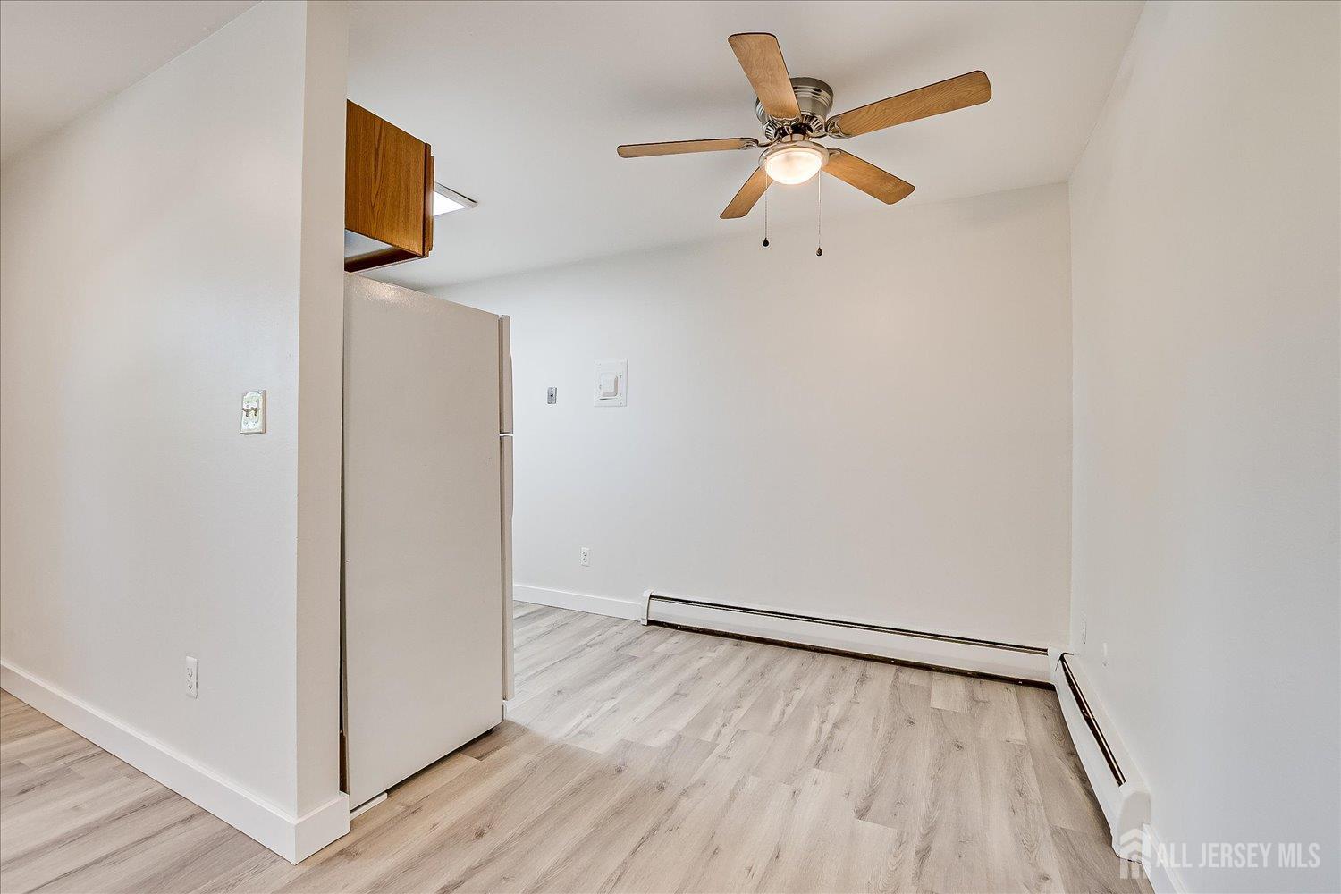 289 Main Street, Unit 4P Spotswood, NJ 08884 - Photo 10 of 22 a view of an empty room with wooden floor