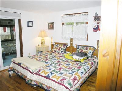 13 Captain Chase Road Dennis Port, MA 02639 - Photo 10 of 13 a bedroom with a bed and wooden floor
