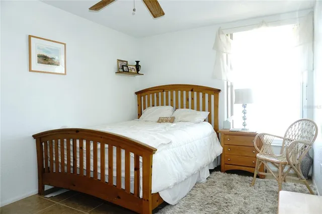 a bedroom with a bed and window