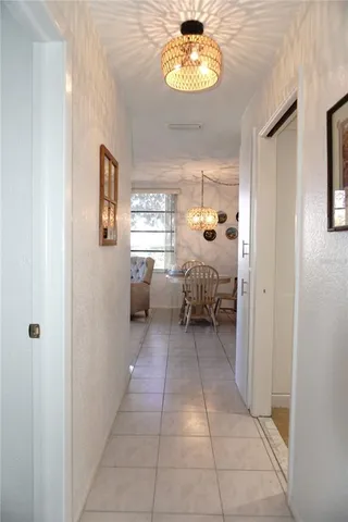 a group of people sitting in a room with a chandelier