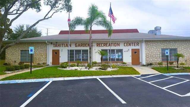 a view of a tennis ground with large windows