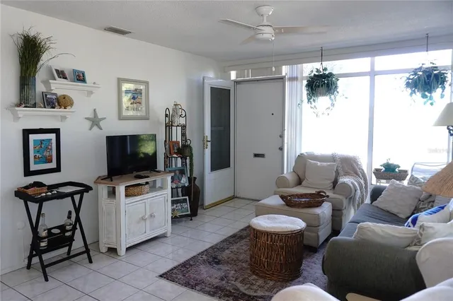 a view of a dining room with furniture a chandelier and wooden floor