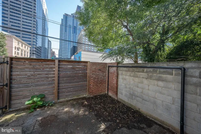 a view of a pathway of a building and trees