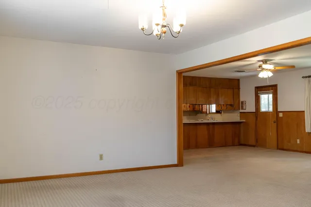 a view of a kitchen with a refrigerator and a sink