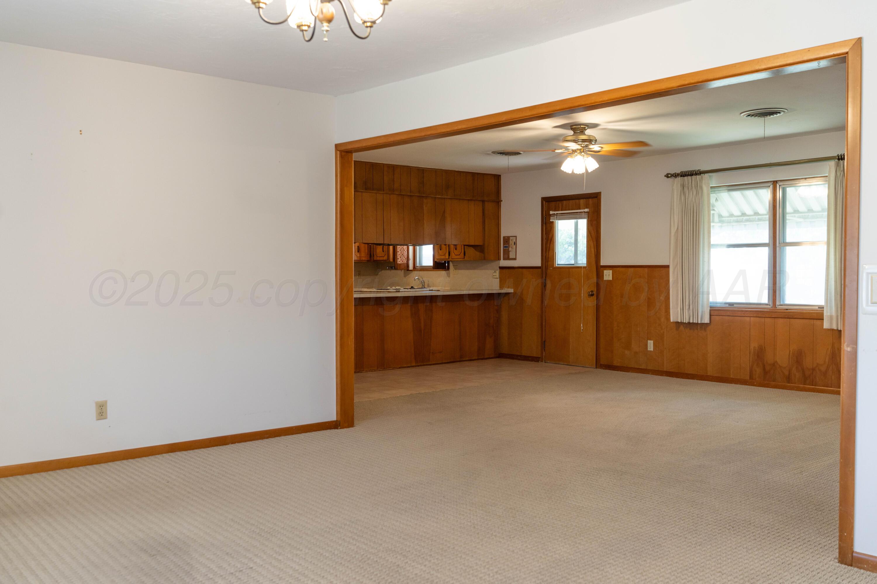 1315 South Canadian Street Wheeler, TX 79096 - Photo 13 of 44 a view of an empty room with a kitchen