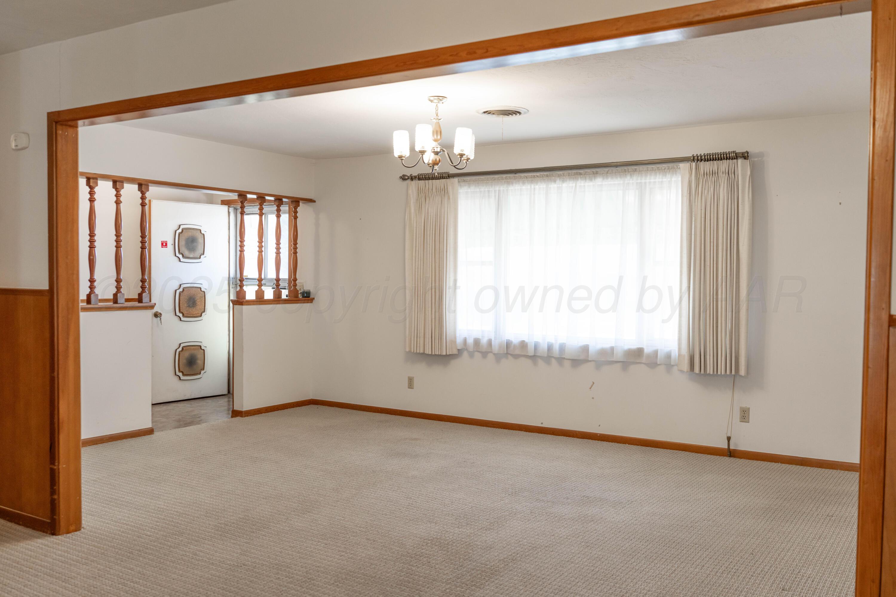 1315 South Canadian Street Wheeler, TX 79096 - Photo 15 of 44 an empty room with windows and entrance