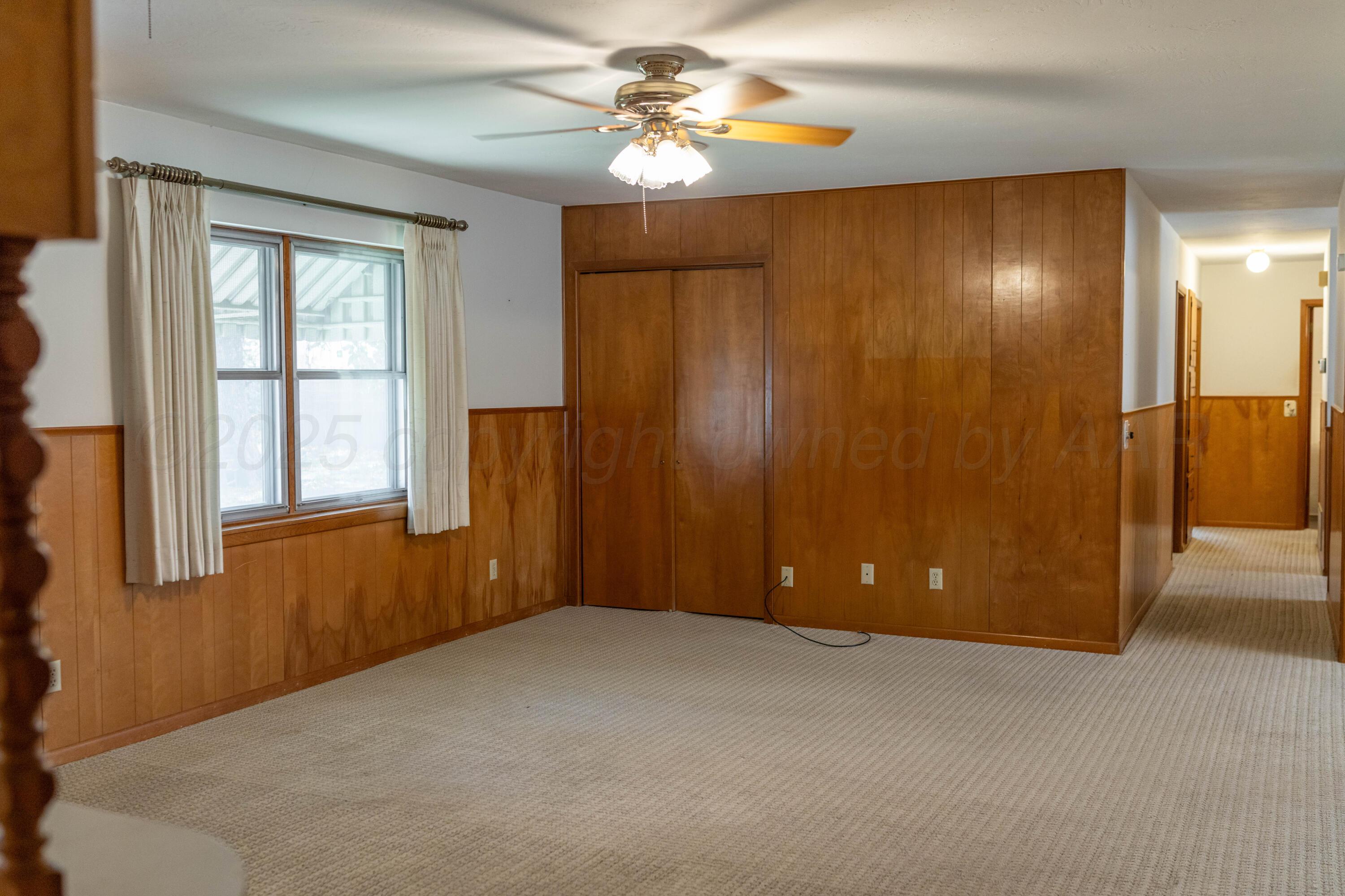 1315 South Canadian Street Wheeler, TX 79096 - Photo 18 of 44 a view of an empty room with chandelier fan and a window