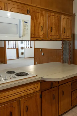 a kitchen with a sink a stove and cabinets