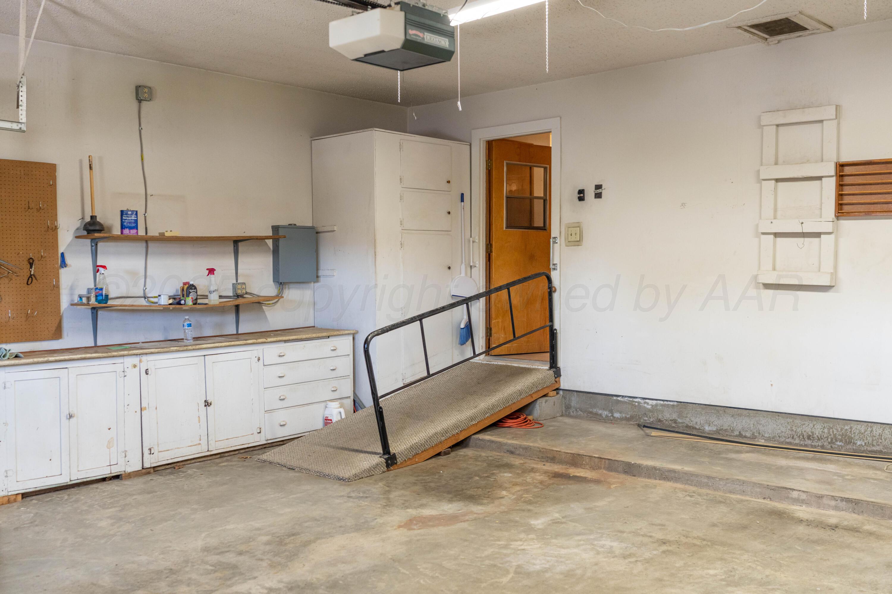 1315 South Canadian Street Wheeler, TX 79096 - Photo 27 of 44 a kitchen with white cabinets and white appliances