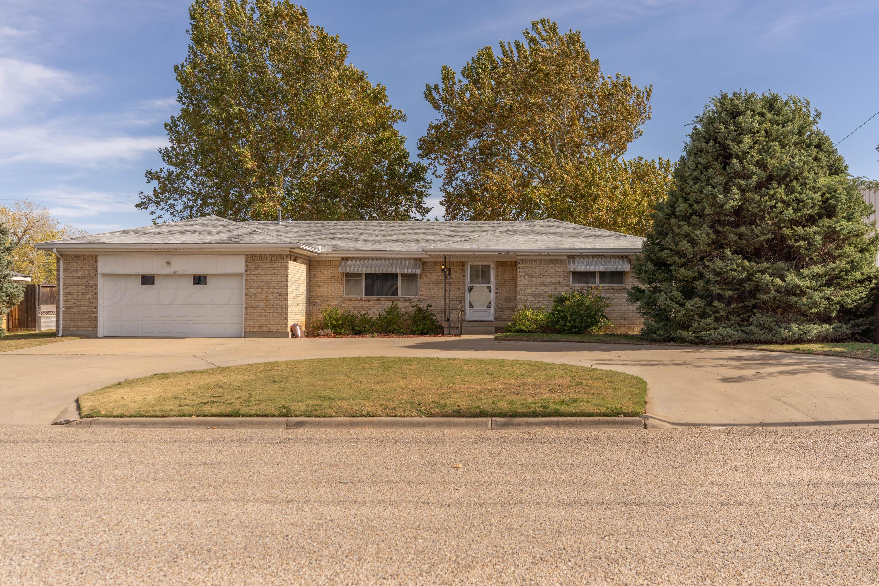 1315 South Canadian Street Wheeler, TX 79096 - Photo 3 of 44 a front view of a house with a yard