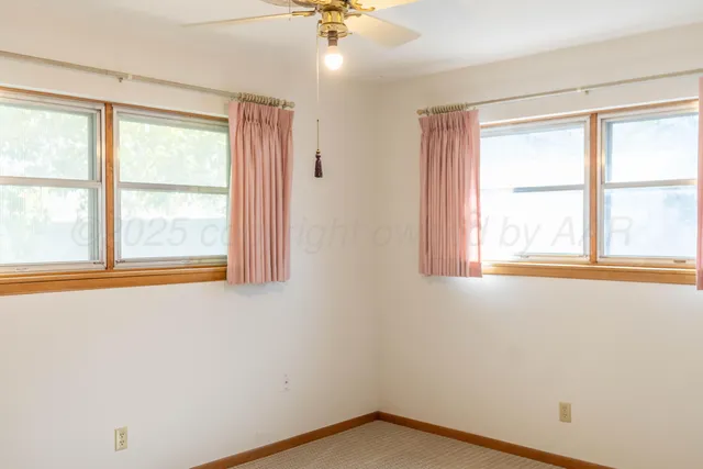 a bathroom with a granite countertop toilet sink and mirror