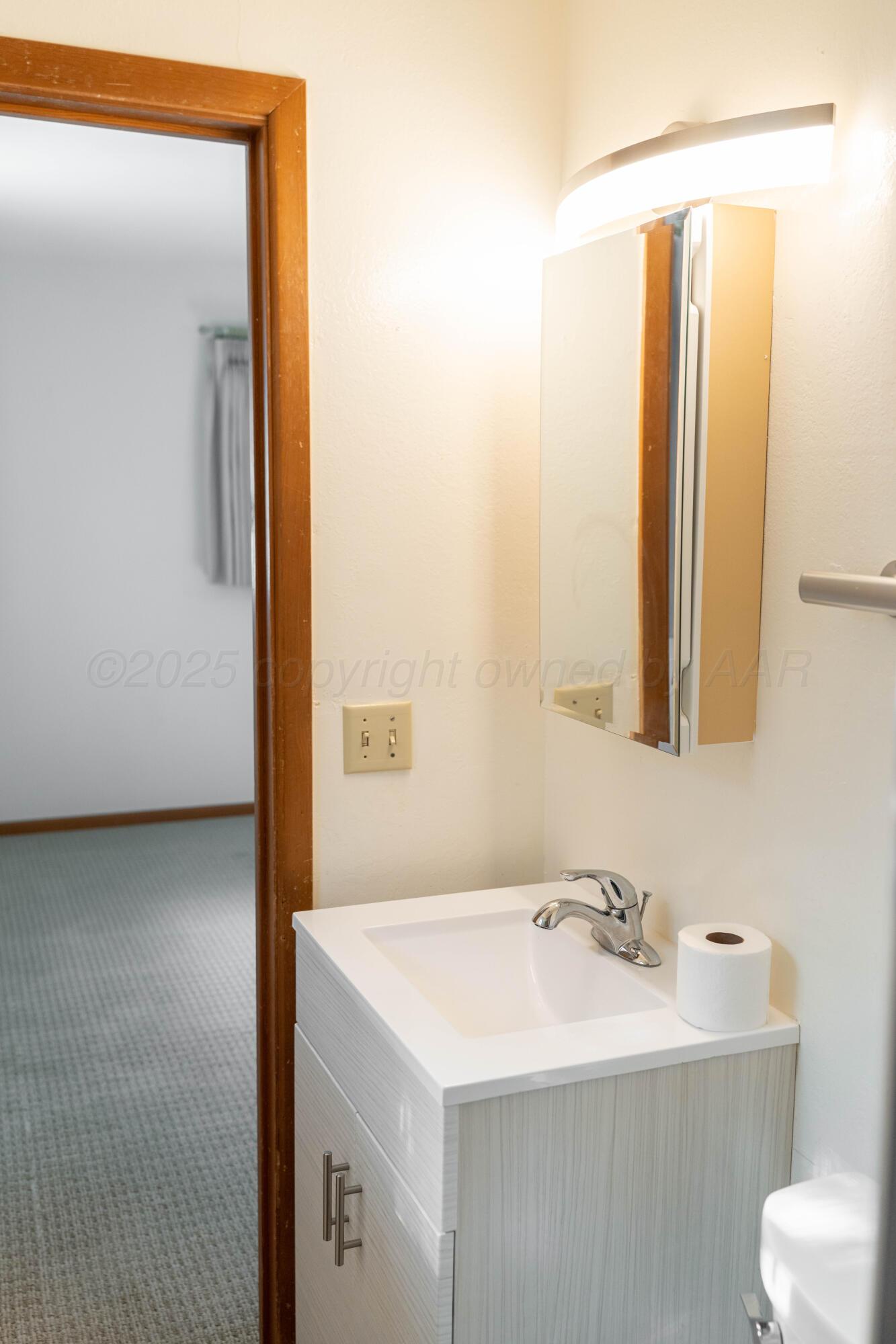 1315 South Canadian Street Wheeler, TX 79096 - Photo 40 of 44 a bathroom with a sink and a mirror