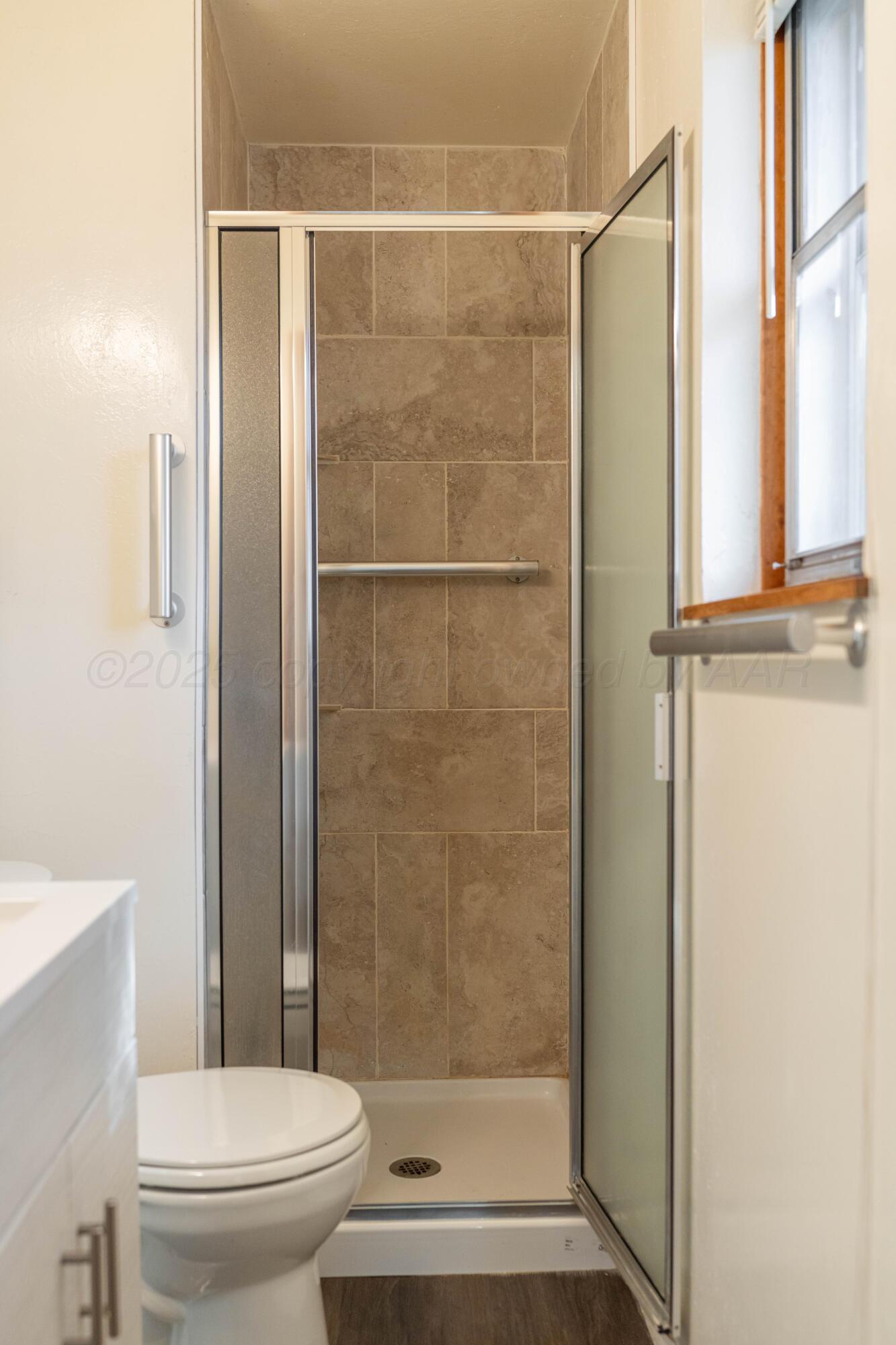 1315 South Canadian Street Wheeler, TX 79096 - Photo 41 of 44 a bathroom with a shower and a toilet