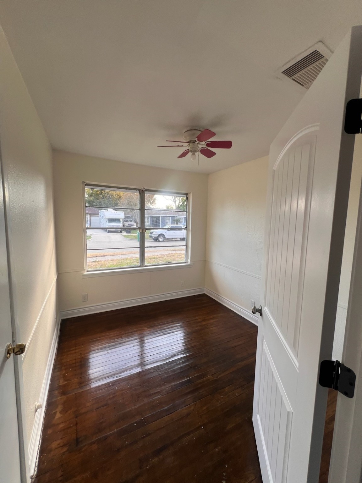 2146 Minnesota Street Houston, TX 77034 - Photo 12 of 22 a view of an empty room with wooden floor and a window