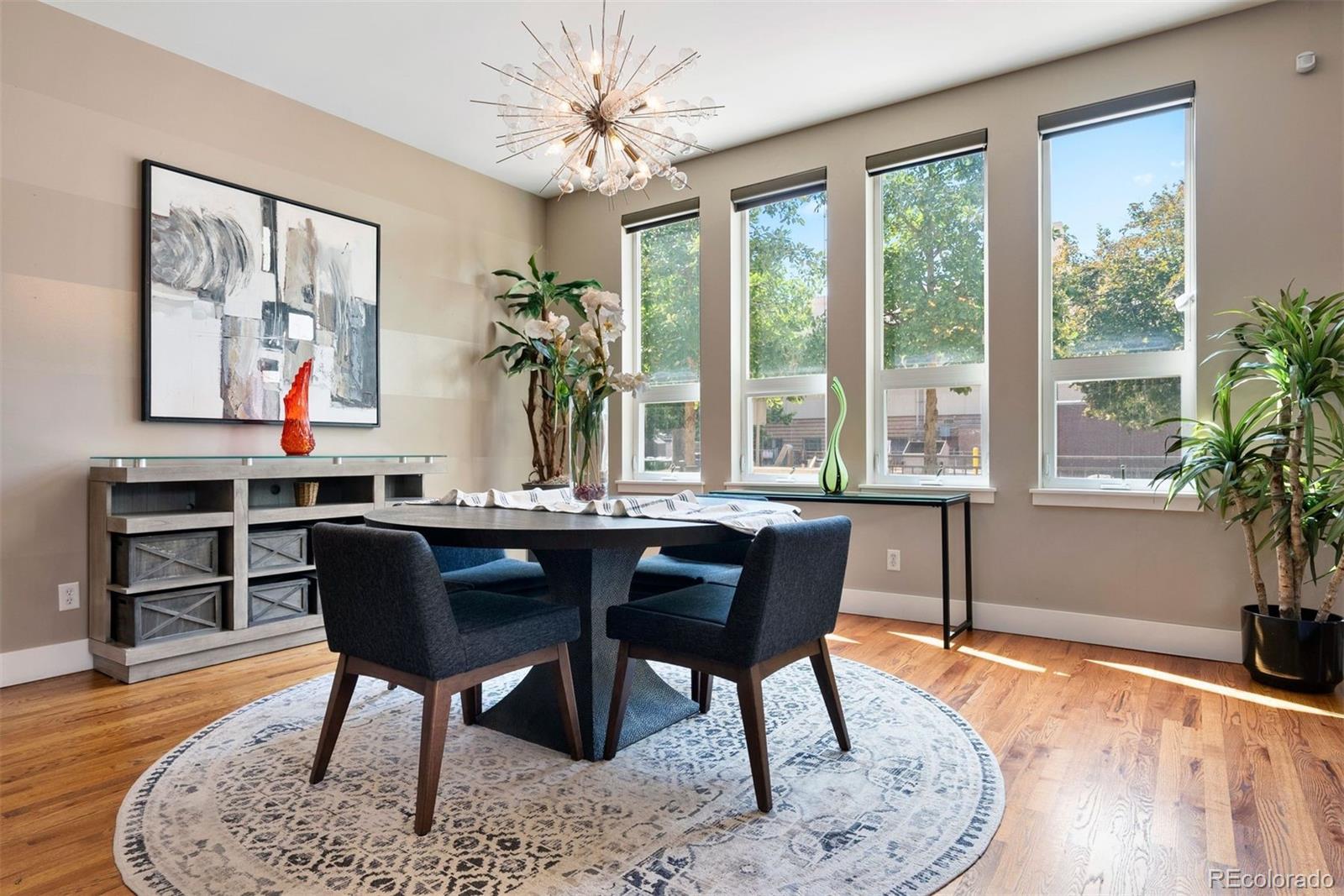 340 South Lafayette Street, Unit 102 Denver, CO 80209 - Photo 12 of 35 a dining room with furniture a rug and wooden floor