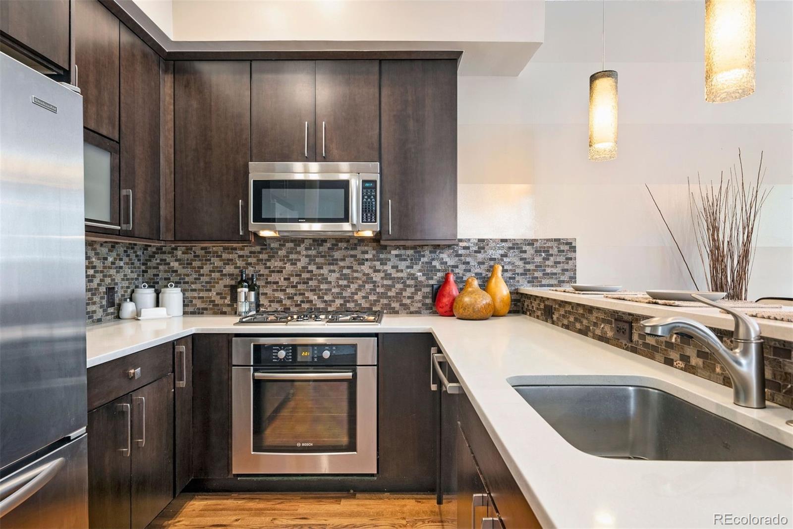 340 South Lafayette Street, Unit 102 Denver, CO 80209 - Photo 15 of 35 a kitchen with stainless steel appliances a stove sink and cabinets