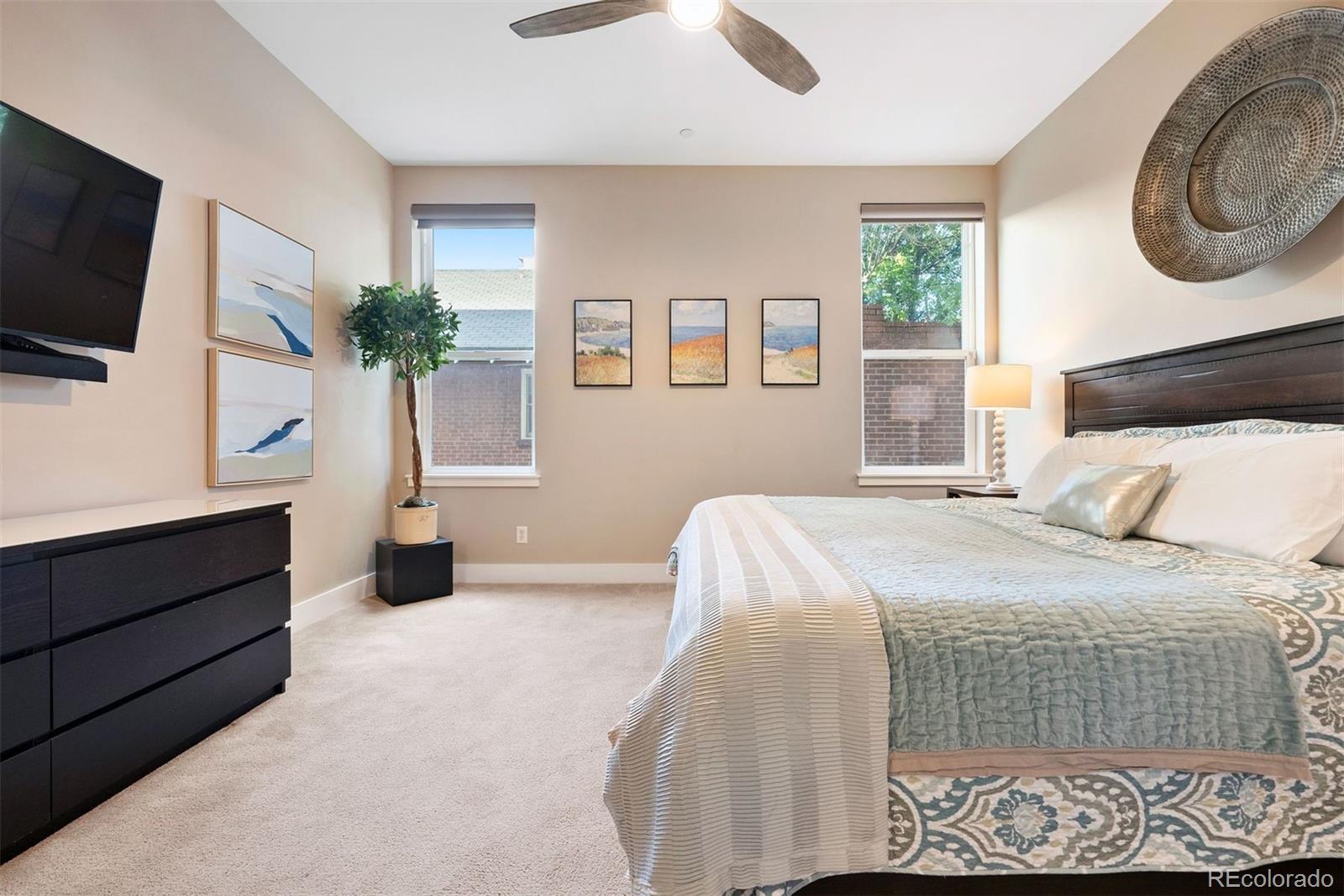 340 South Lafayette Street, Unit 102 Denver, CO 80209 - Photo 17 of 35 a bedroom with a bed and a flat tv screen on dresser