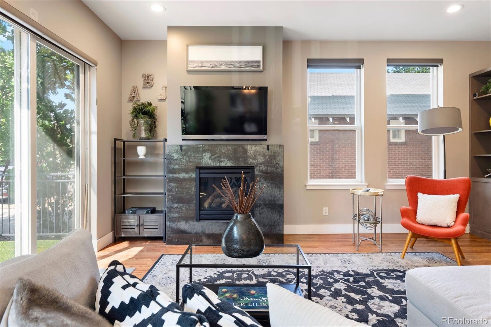 340 South Lafayette Street, Unit 102 Denver, CO 80209 - Photo 2 of 35 a living room with fireplace furniture and a flat screen tv