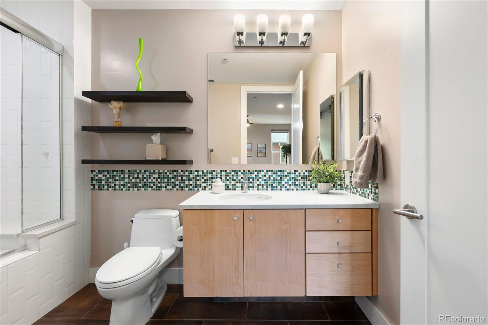 340 South Lafayette Street, Unit 102 Denver, CO 80209 - Photo 21 of 35 a bathroom with a sink a toilet and mirror