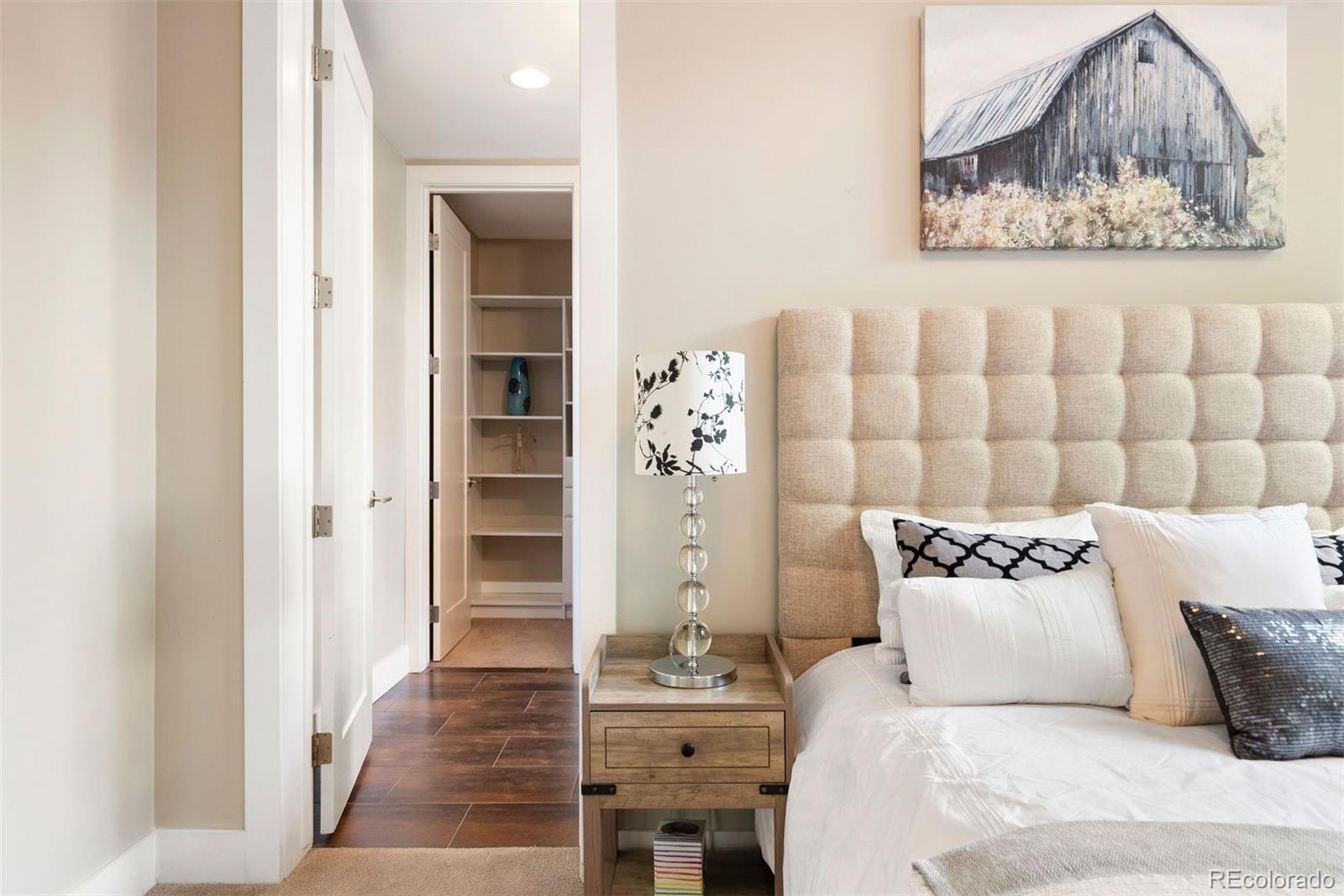 340 South Lafayette Street, Unit 102 Denver, CO 80209 - Photo 26 of 35 a bedroom with a bed and a painting on the wall