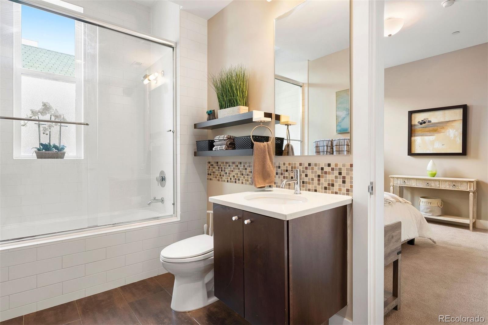 340 South Lafayette Street, Unit 102 Denver, CO 80209 - Photo 27 of 35 a bathroom with a granite countertop sink toilet and shower