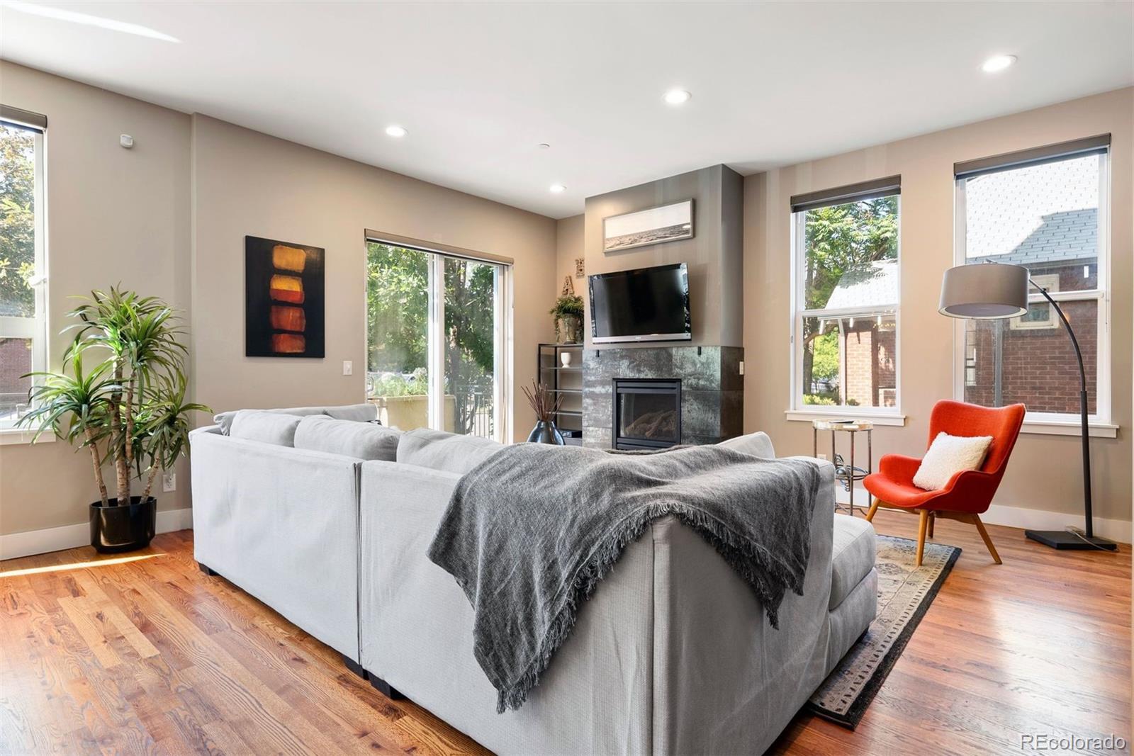 340 South Lafayette Street, Unit 102 Denver, CO 80209 - Photo 7 of 35 a living room with furniture a flat screen tv and a fireplace