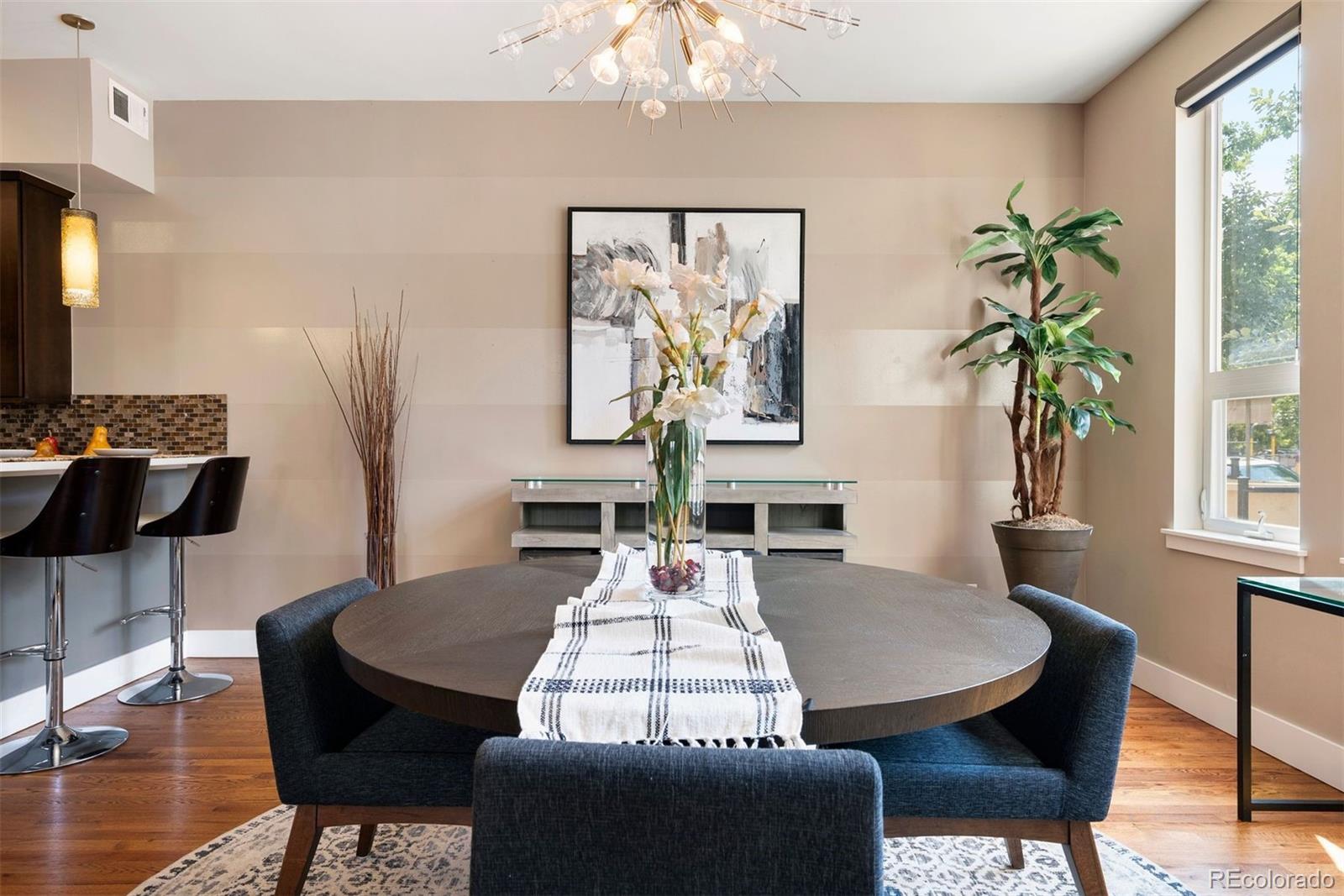 340 South Lafayette Street, Unit 102 Denver, CO 80209 - Photo 10 of 35 a view of a dining room with furniture window and wooden floor