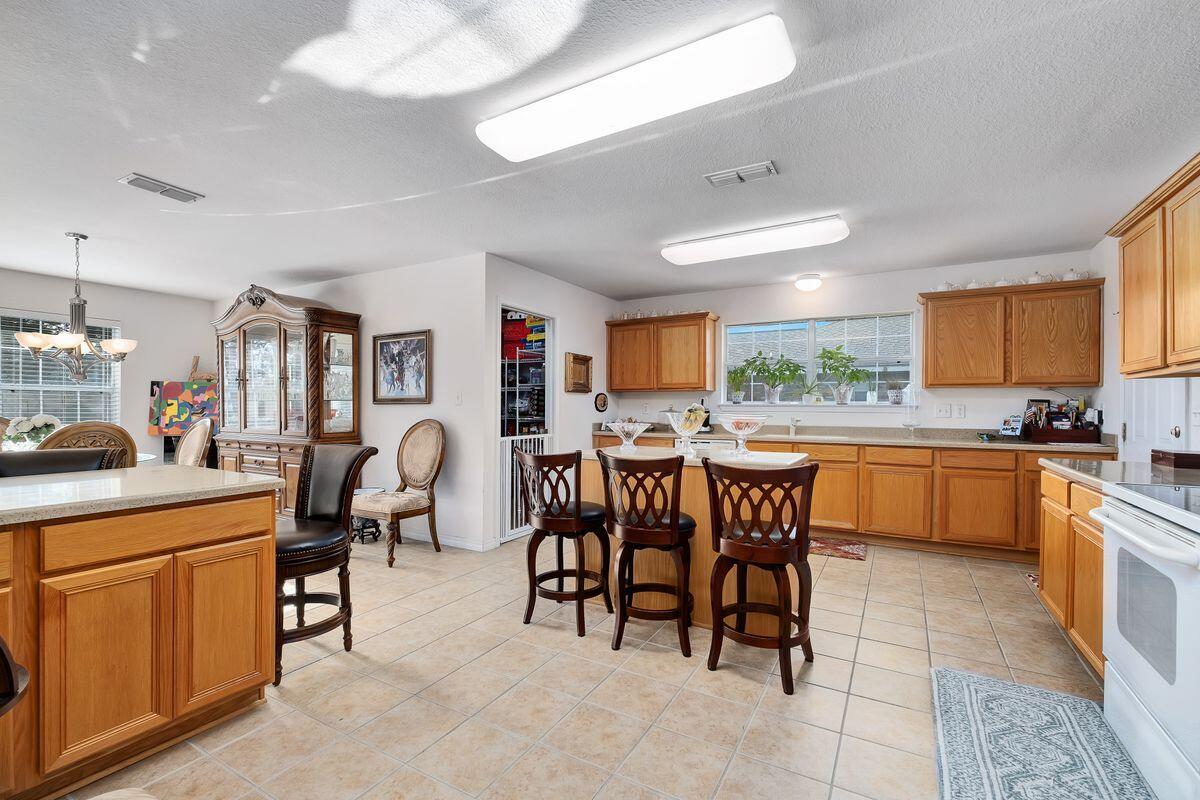 621 East Shipwreck Road Santa Rosa Beach, FL 32459 - Photo 11 of 25 a large kitchen with a table and chairs